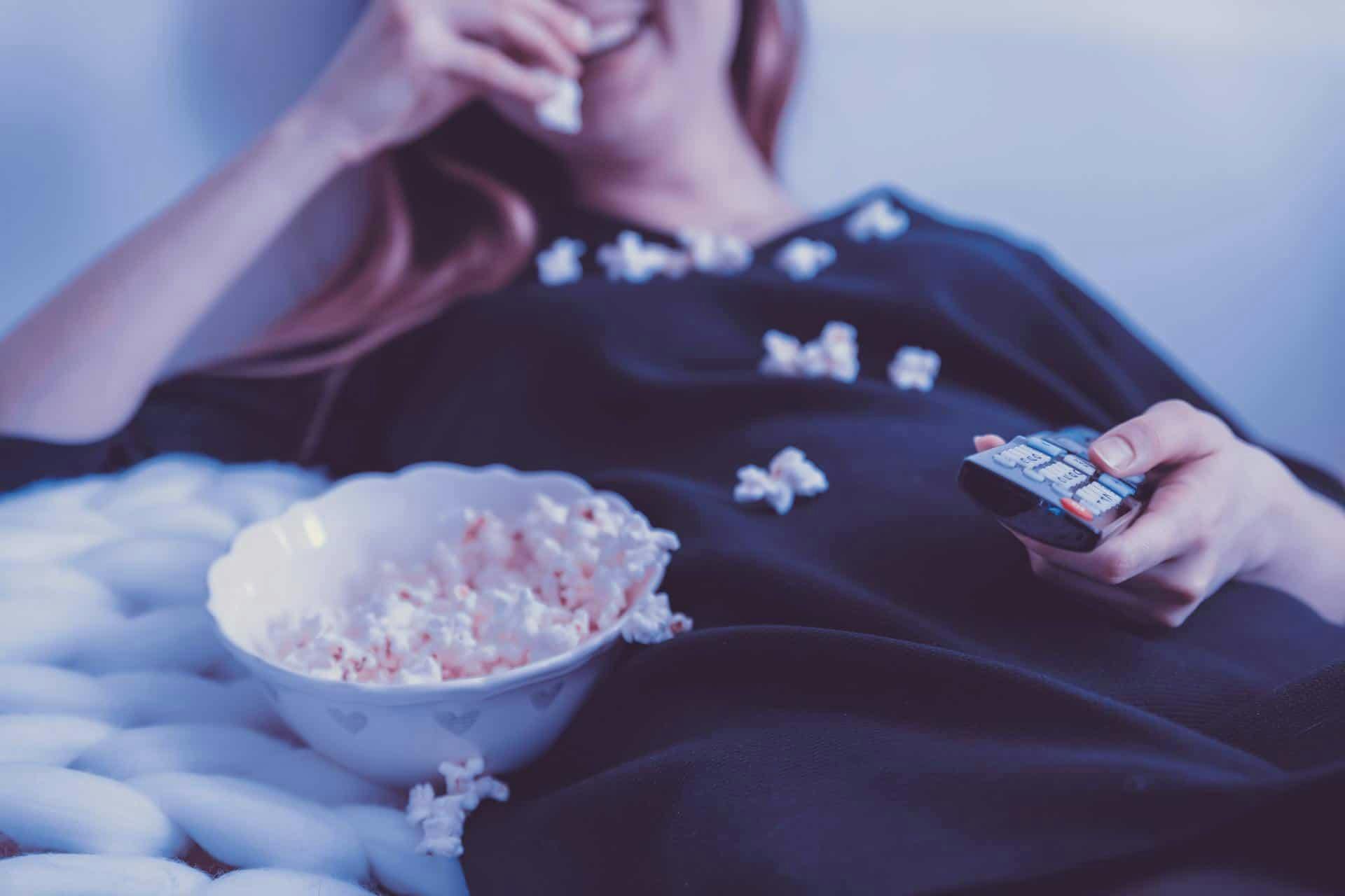woman eating popcorn watching movie